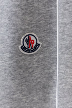 Moncler sweatpants leg with circular logo patch and drawstring cord