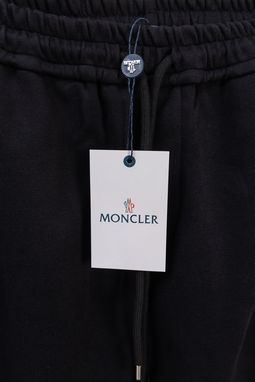 Moncler pants with elastic waistband, drawstring, and MONCLER hang tag