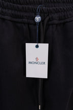 Moncler pants with elastic waistband, drawstring, and MONCLER hang tag