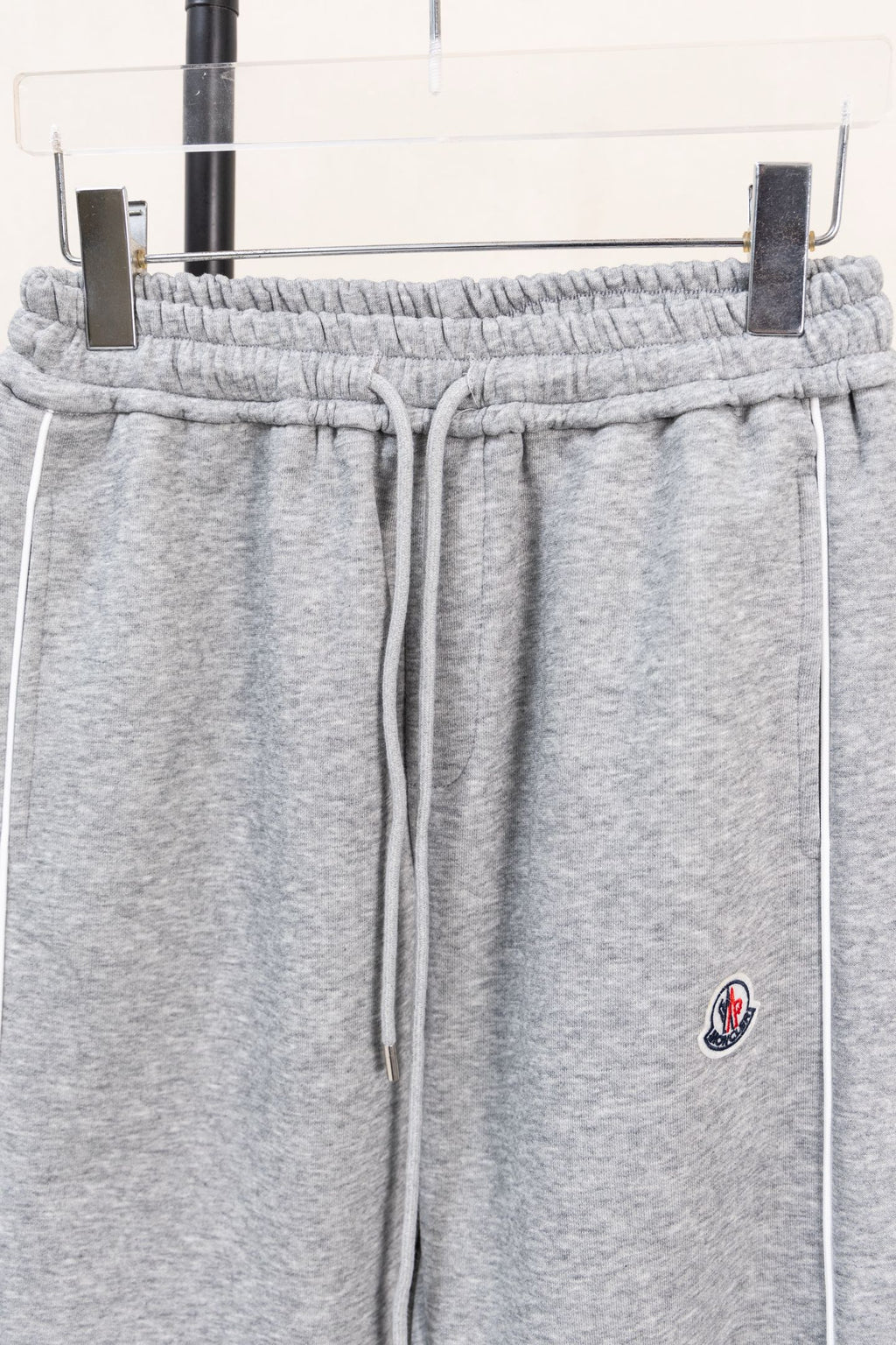 Moncler gray sweatpants with elastic waistband, drawstring, and side emblem
