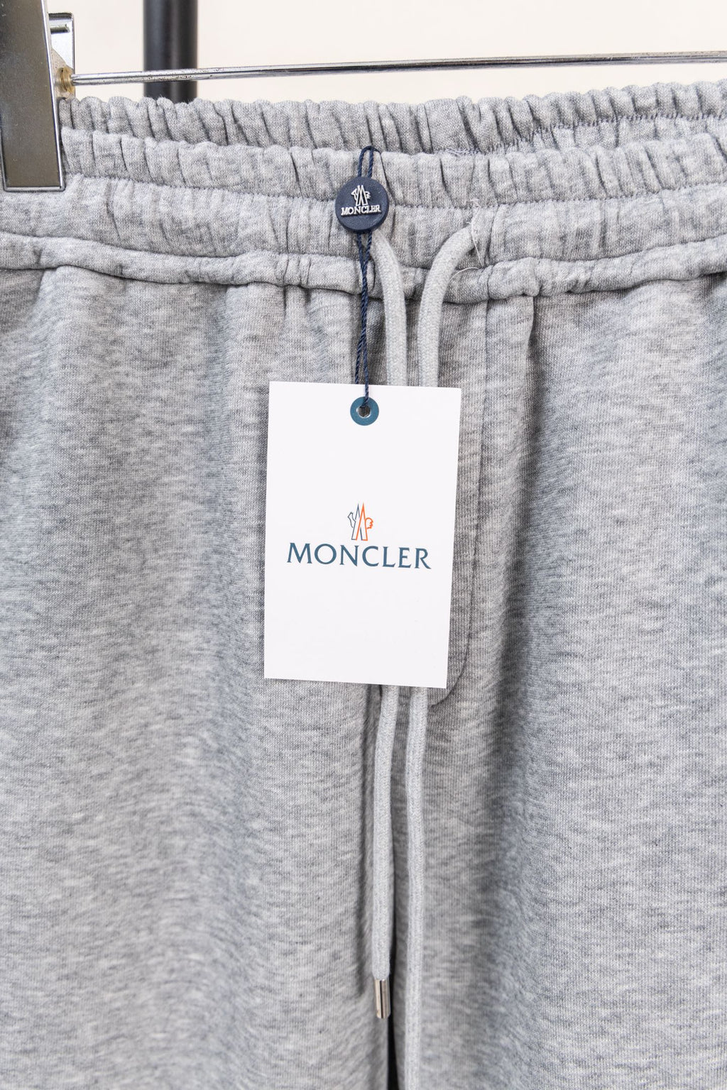 Moncler gray sweatpants waistband with elastic and hanging brand tag