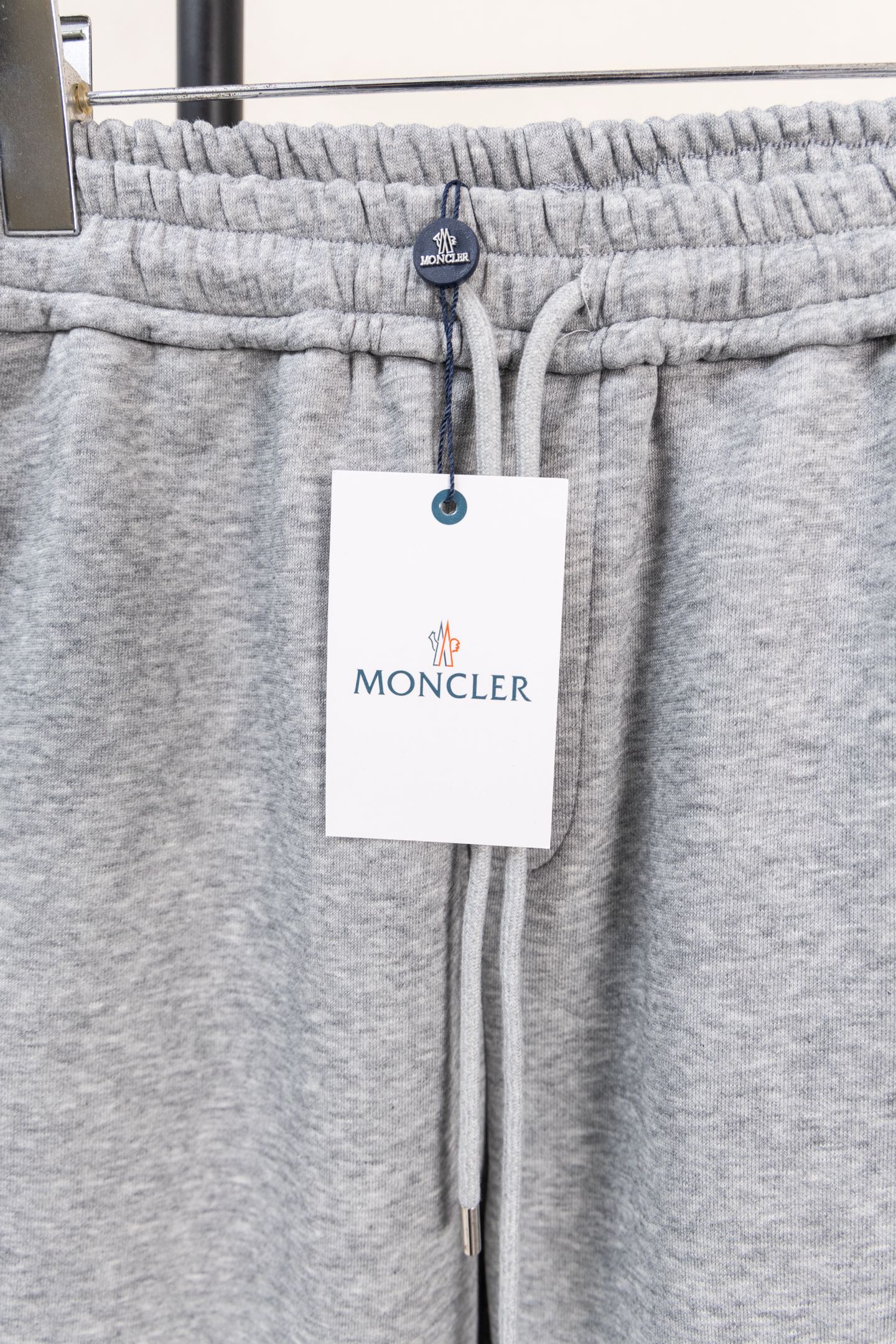Moncler gray sweatpants waistband with elastic and hanging brand tag