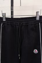 Black elastic-waist pants with drawstring and Moncler logo patch