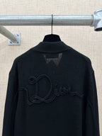 Dark knit jacket back with raised logo embroidery and ribbed high collar