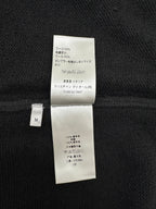 Dark knit jacket interior care label with composition details and size M