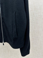 Dark knit jacket side with pocket seam and ribbed cuff