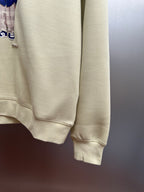 Cream sweatshirt sleeve cuff and hem with teddy graphic partial