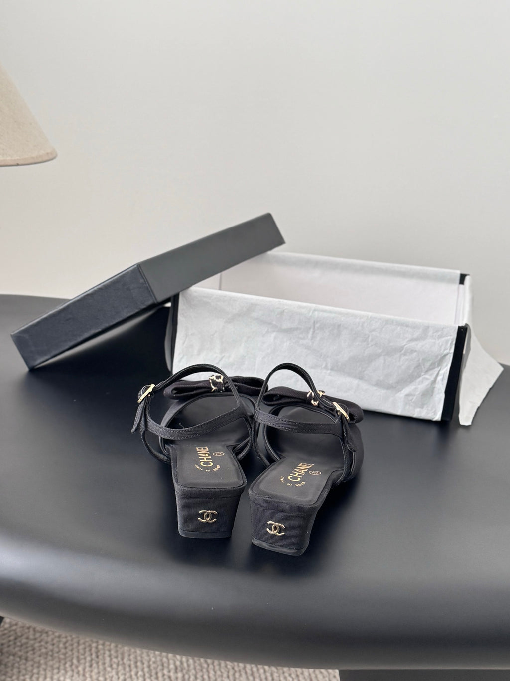 Dark Chanel slingback sandals with bow accents and low heel