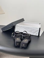 Dark Chanel slingback sandals with bow accents and low heel