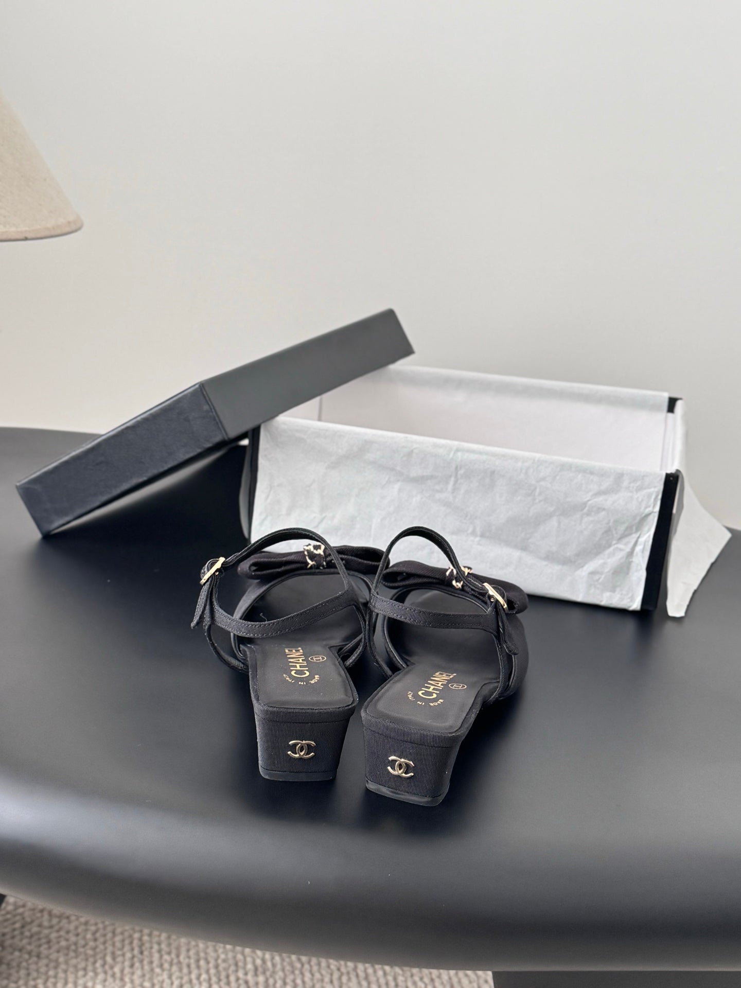 Dark Chanel slingback sandals with bow accents and low heel
