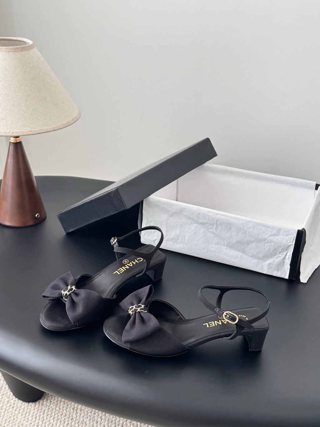 Dark satin bow sandals with low heel and ankle strap, gold-tone links
