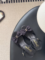Dark bow slingback sandals with gold-tone charm details