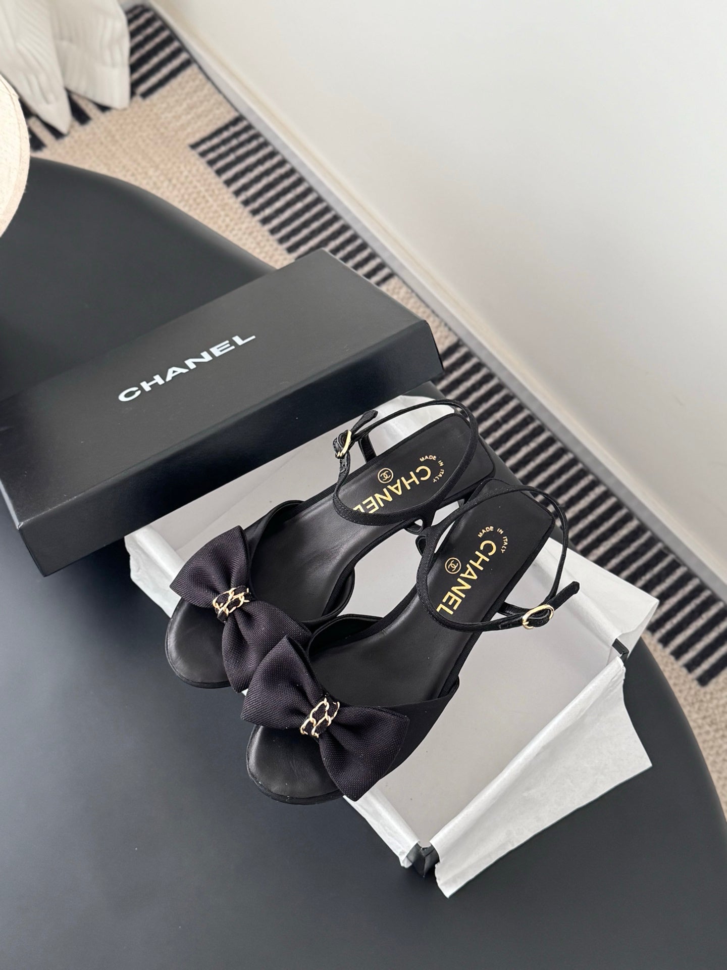 Dark bow slingback sandals with gold-tone hardware, with Chanel box nearby