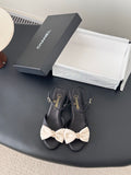 Black bow sandals with gold-tone ankle buckle and Chanel logo on straps