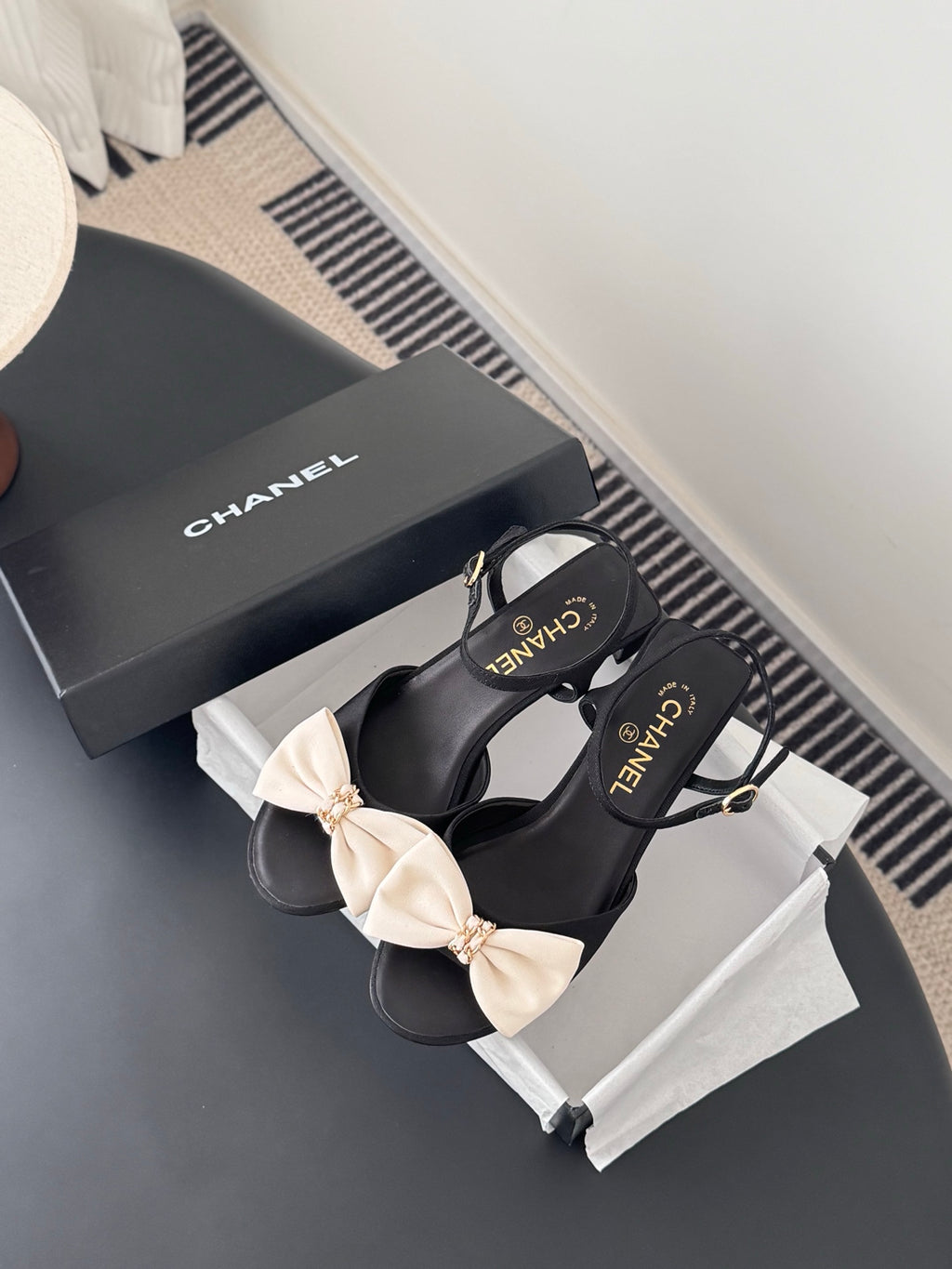 Black bow slingback sandals with cream bows and Chanel logo on straps