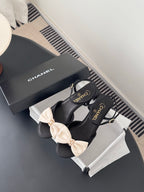 Black bow slingback sandals with cream bows and Chanel logo on straps