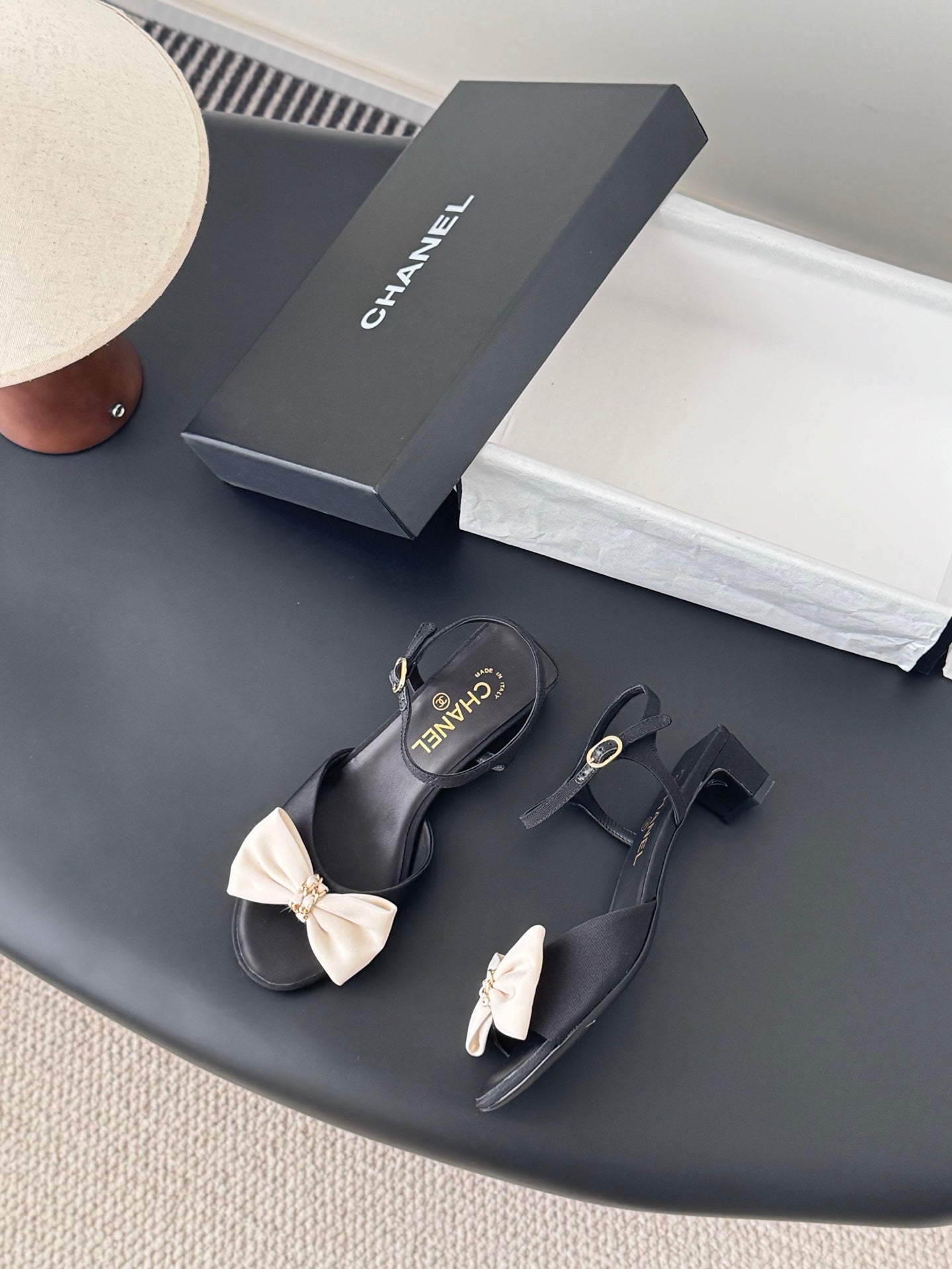 Black bow sandals with slingback strap and gold-tone buckles, Chanel logo