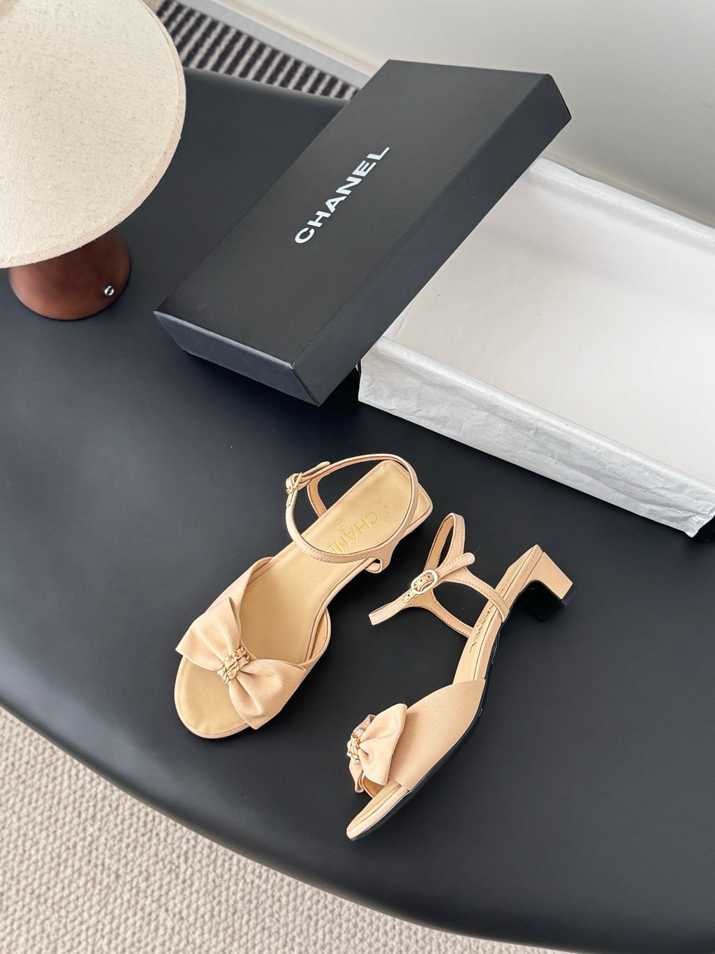 Beige heeled sandals with bow accents and ankle strap