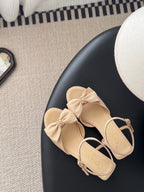 Beige slingback sandals with bow on vamp and ankle strap