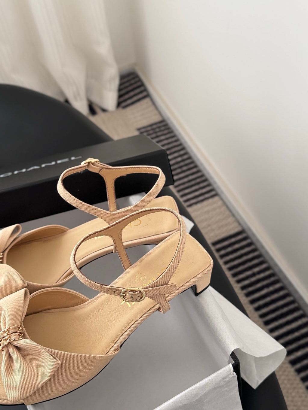 Beige slingback sandals with bow and gold-tone logo hardware, low heel