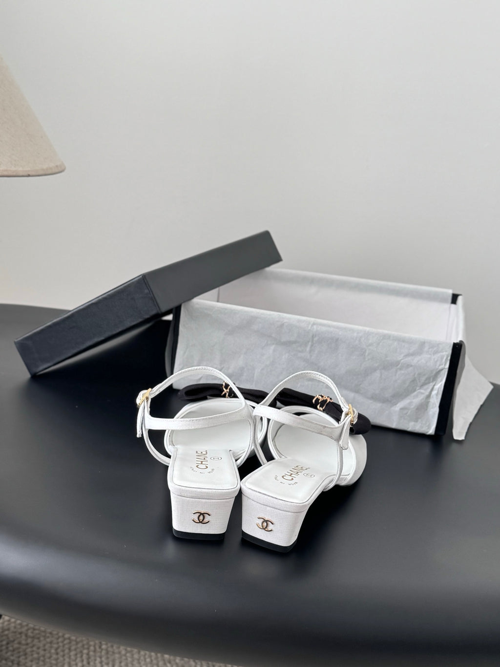 Chanel bow-strap sandals in white with black knot and gold buckles, kitten heel