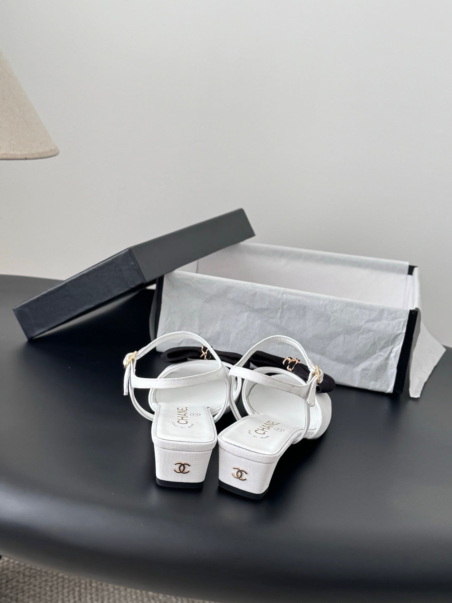 Chanel bow-strap sandals in white with black knot and gold buckles, kitten heel