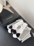 Chanel sandals with white straps and black bow, gold buckle, kitten heel