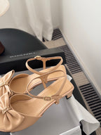 Beige bow sandals with T-strap design and low block heel