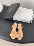 Beige satin bow sandals with ankle straps and low block heels