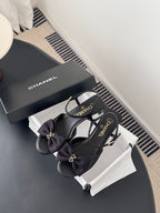 Chanel women's dark bow sandals with ankle strap and gold-tone logo, on box