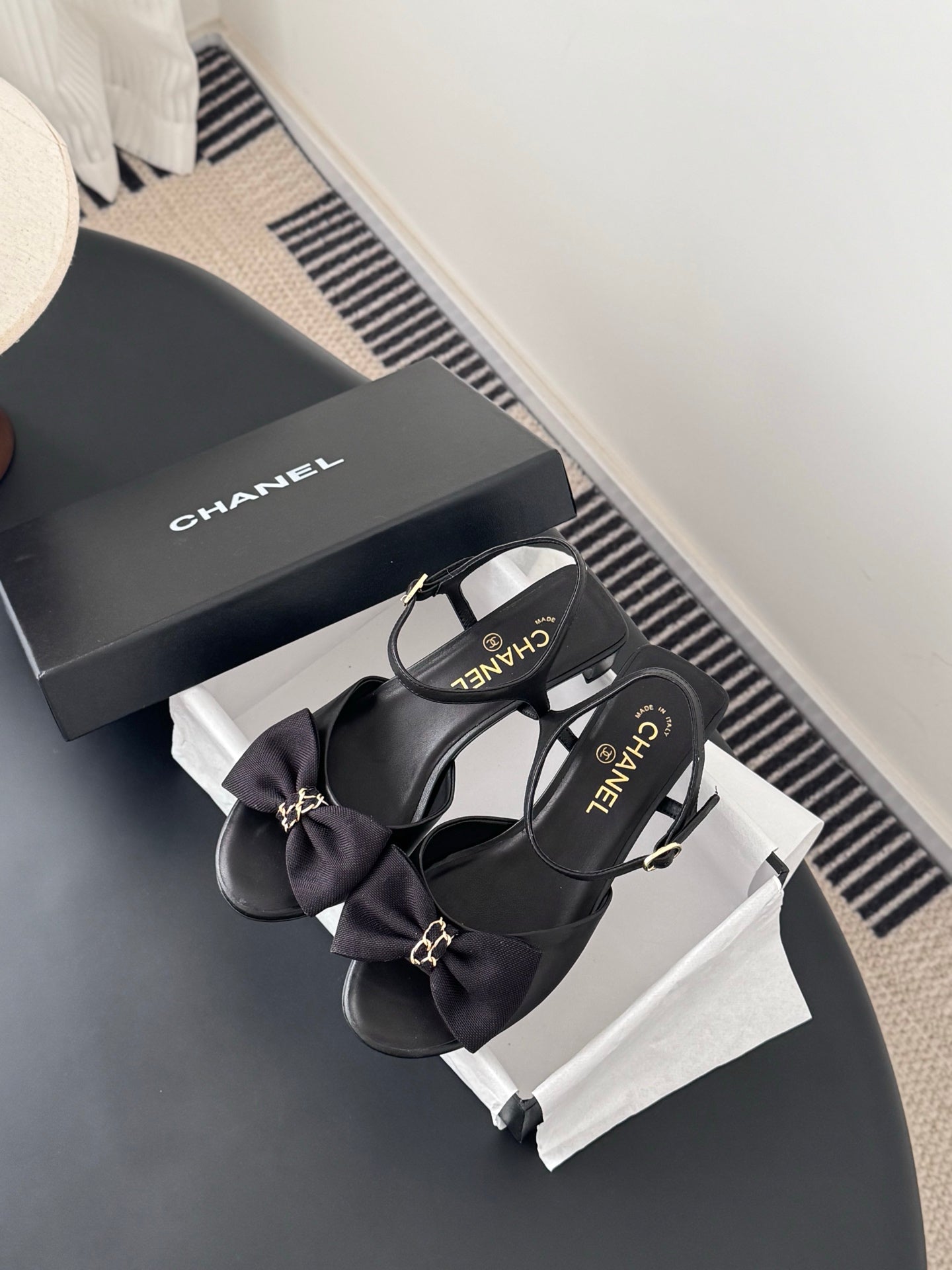 Chanel women's dark bow sandals with ankle strap and gold-tone logo, on box