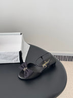 Chanel women's dark bow slingback sandal with low block heel and gold hardware