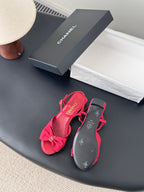 Pink slingback sandals with bow embellishment and logo footbed, block heel