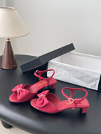 Pink open-toe slingback sandals with bow detail and ankle strap, block heel
