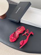Pink strappy sandals with bow detail, ankle strap, and mid-height block heel