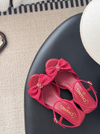 Pink slingback sandals with large bow and logo hardware, open toe