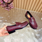 Burgundy leather loafer with gold crest and plaid lining, side and sole view