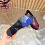 Leather loafer sole with logo print and maroon upper, metal hardware