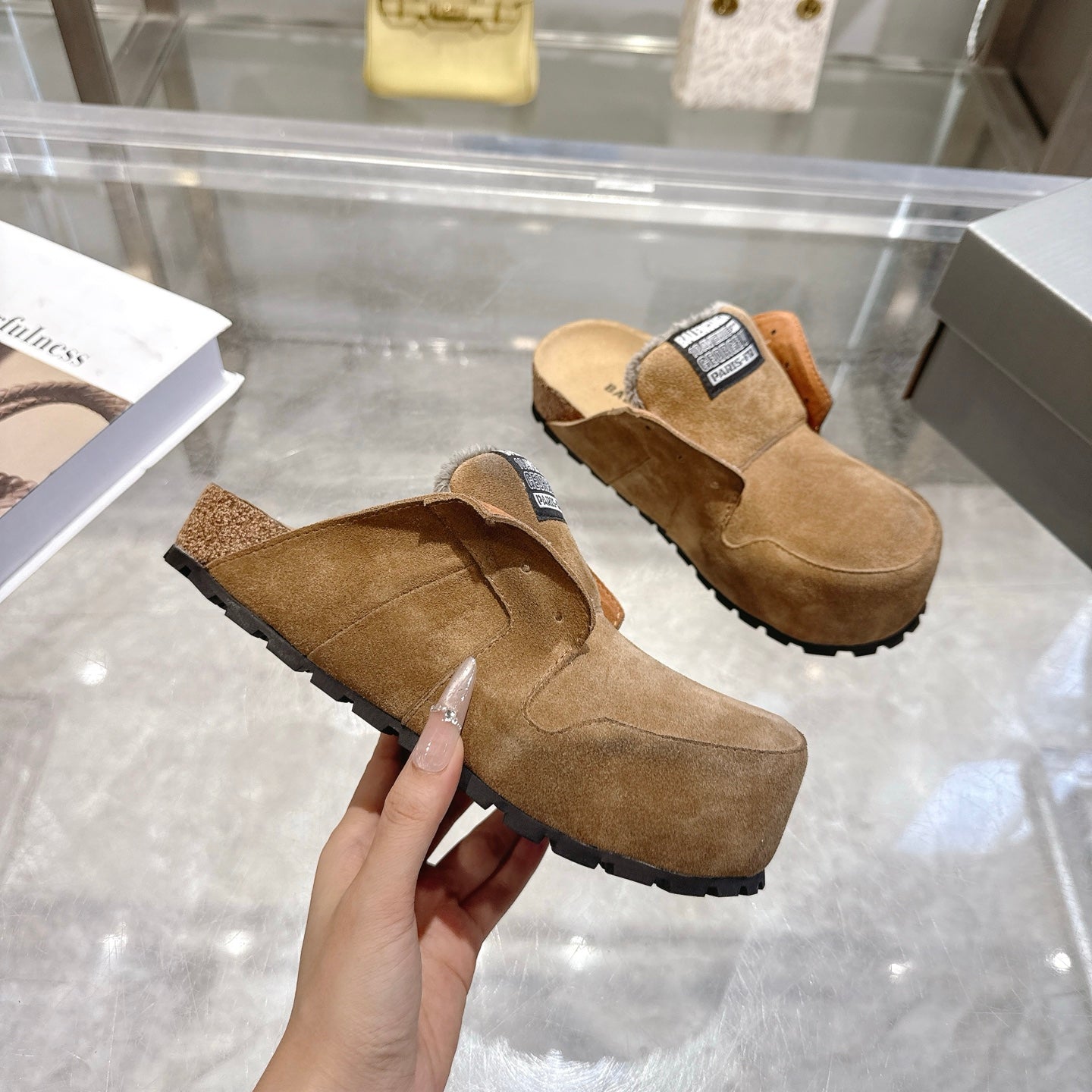 Balenciaga brown suede slip-on mules with fur lining and chunky tread outsole