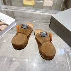 Balenciaga brown slip-on clogs with black logo patch, fur collar, and tread sole