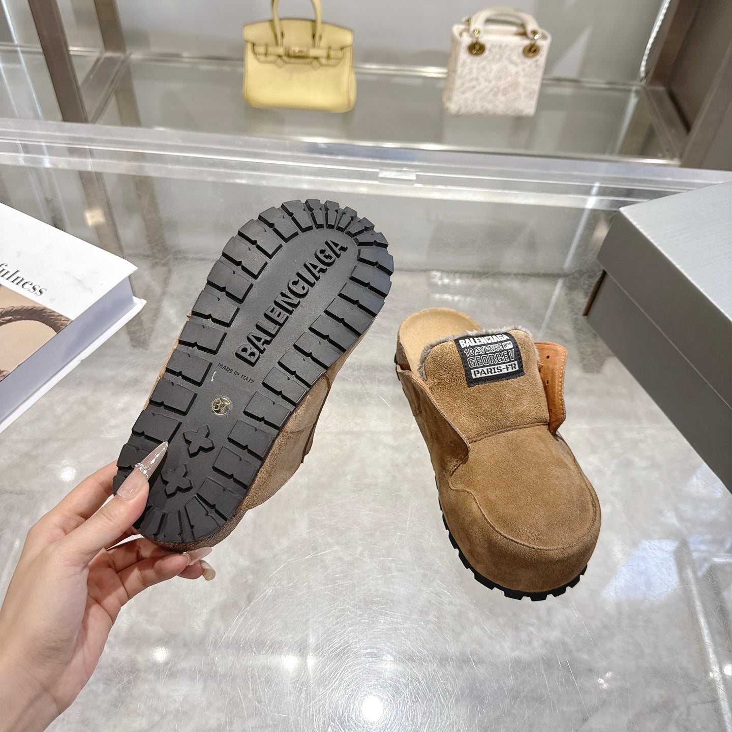 Balenciaga suede slip-on shoes with visible outsole tread and black logo patch