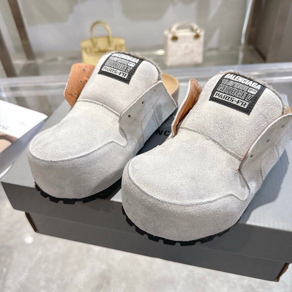 Balenciaga slip-on shoes in light gray suede, top/front view with branded collar labels