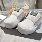 Balenciaga slip-on shoes in light gray suede, top/front view with branded collar labels