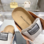 Balenciaga slip-on shoes close-up, shearling collar with BALENCIAGA logo patch and tan insole