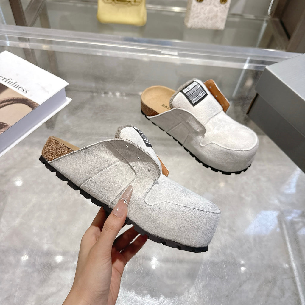 Balenciaga slip-on shoes in light gray suede, hand-held close view of rounded toe and strap