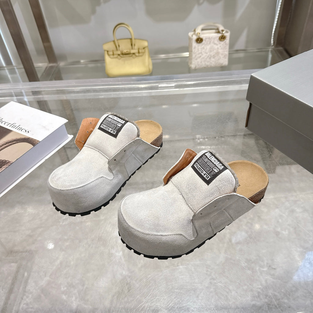 Balenciaga slip-on shoes in light gray suede, front and side view with branded patch on collar
