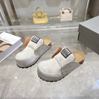 Balenciaga slip-on shoes in light gray suede, front and side view with branded patch on collar