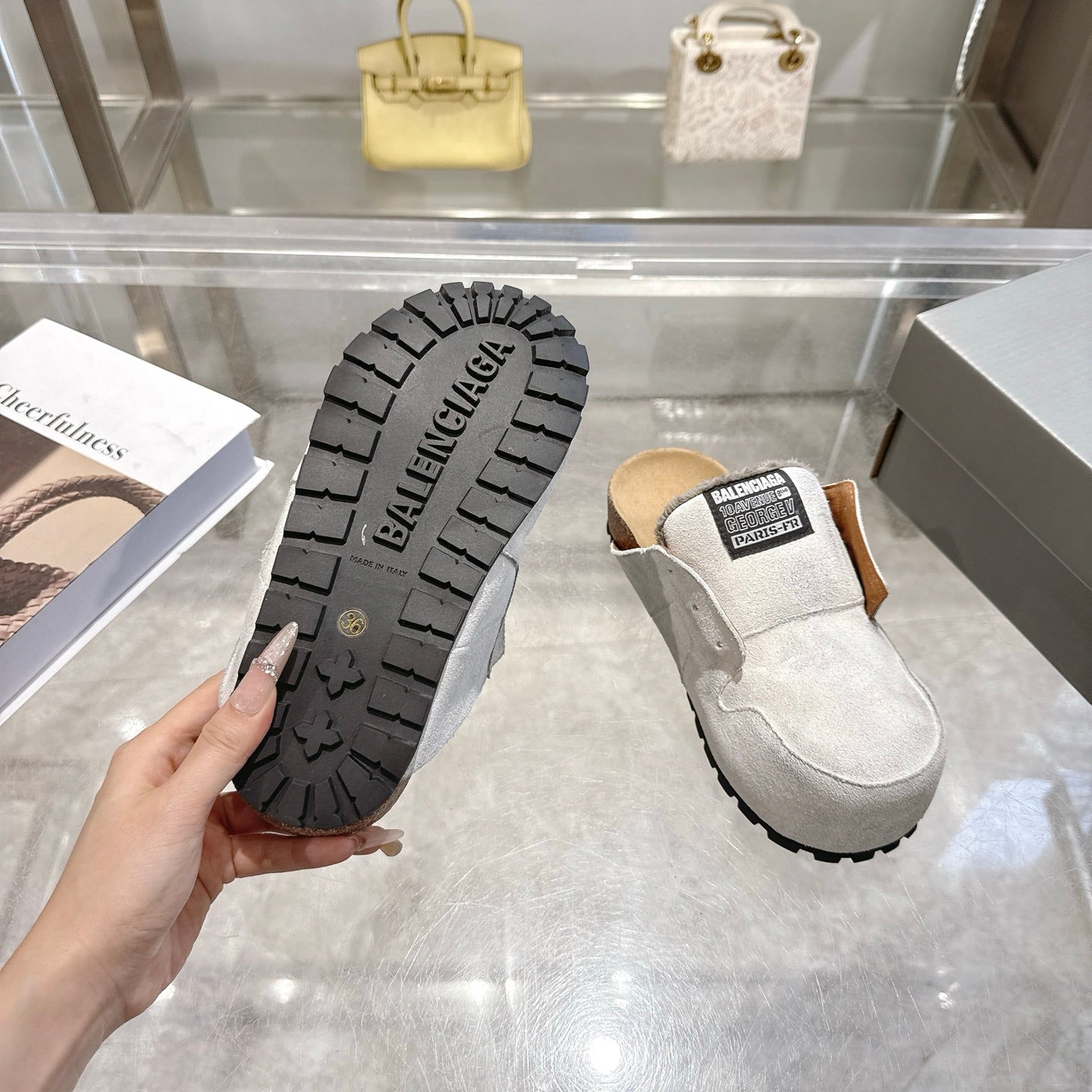 Balenciaga slip-on shoes, outsole view shows patterned tread on rubber sole and light gray upper