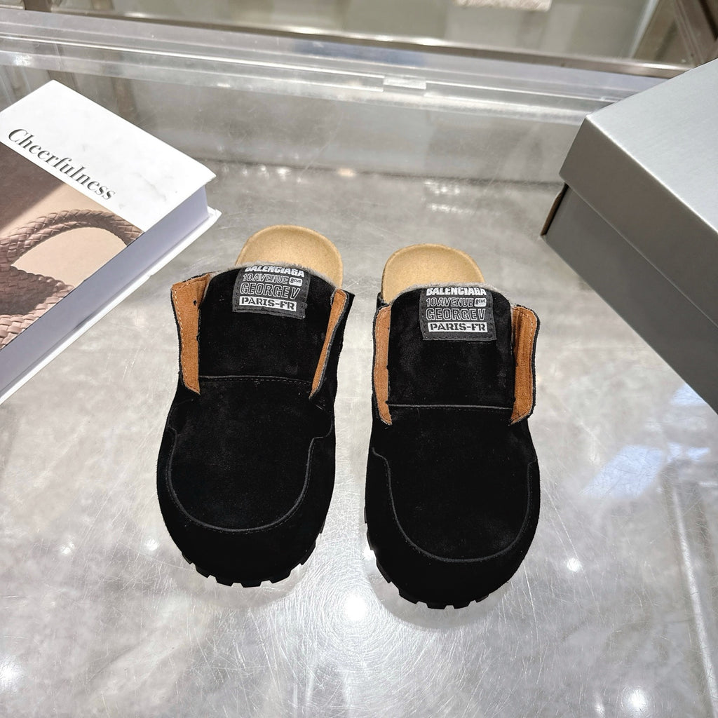 Black slip-on mule shoes with Balenciaga logo patch and chunky tread sole
