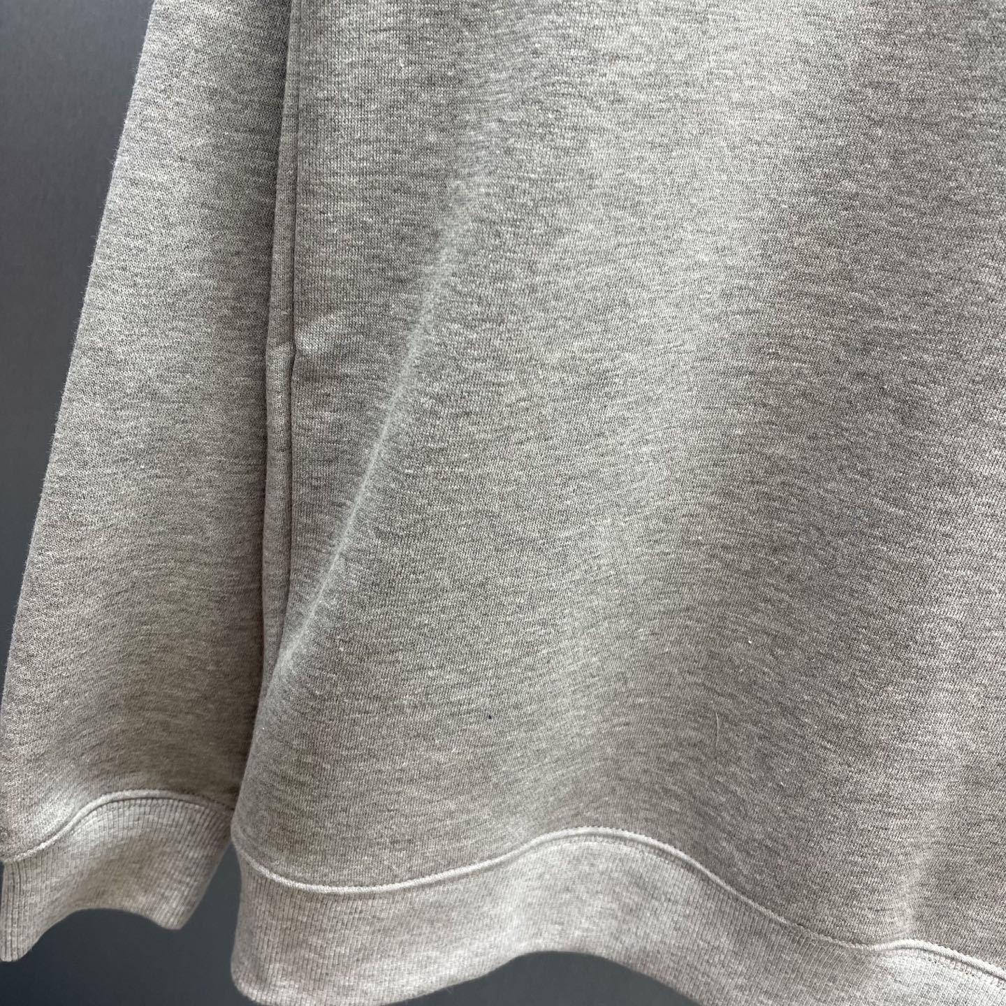 Light gray Gucci sweatshirt hem and side seam detail